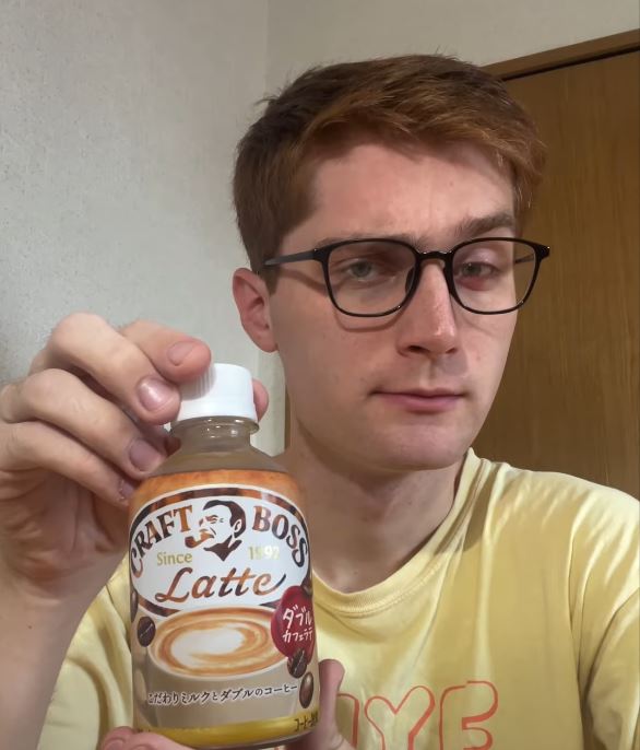 Me, white guy with glasses, holding up bottled coffee